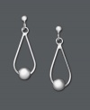 Sweet sophistication in silver. These elegant teardrop earrings feature a central accent bead. Set in sterling silver. Approximate drop: 1/2 inch.