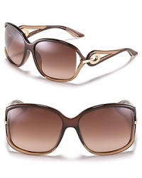 Large oversized sunglasses with with circular open metal temples for a glamorous touch. Large oversized sunglasses with with circular open metal temples for a glamorous touch.