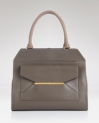 A chic, ever-versatile Tory Burch handbag is dressed up in leather with textured suede trims. An exterior envelope pocket details this day bag, which opens to a spacious interior with multiple pockets. A chic, ever-versatile Tory Burch handbag is dressed up in leather with textured suede trims. An exterior envelope pocket details this day bag, which opens to a spacious interior with multiple pockets.