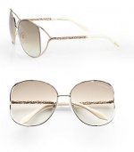 A chic metal style with intricately detailed temples and modern floating lens. Available in rose gold/ivory with brown gradient lens. Logo etched lens100% UV protectionMade in Italy 