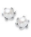 Inspired by heirloom jewelry, these traditional stud earrings feature an elegant mix of cultured freshwater pearls (7 mm) and sparkling diamond accents. Set in sterling silver. Approximate diameter: 1/2 inch.