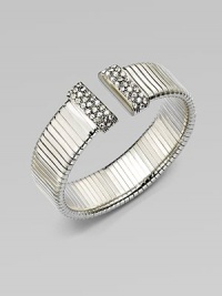 An elegantly ribbed, flexible cuff with Swarovski crystal caps.CrystalSilverplatedDiameter, about 2¼Made in Italy