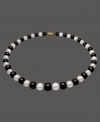 The perfect picture of contrast. This necklace features a strand of alternating cultured freshwater pearls (8-12 mm) and onyx  beads (8-12 mm). Set in 14k gold. Approximate length: 18 inches.