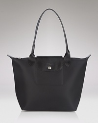 Leather-kissed nylon is at once sporty and luxe, perfect for hauling everything from your gym clothes to the European editions of your favorite fashion magazines. Leather-kissed nylon is at once sporty and luxe, perfect for hauling everything from your gym clothes to the European editions of your favorite fashion magazines.