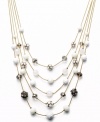 Try a fresh palette of color to brighten your look. This five-row illusion necklace by INC International Concepts combines plastic white beads, black glass beads, plastic fireballs, glass fireballs, white plastic beads, and frosted plastic beads. Set in gold tone mixed metal. Approximate length: 18 inches + 3-inch extender. Approximate drop: 3-1/2 inches.