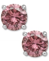 Perfection in pink. These sparkling stud earrings feature round-cut pink diamonds (1-1/2 ct. t.w.) in a four-prong setting of 14k white gold. Approximate diameter: 1/4 inch.