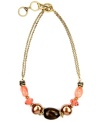 A cool splash of color. Jones New York's double strand necklace incorporates coral and shimmery beige-colored acrylic beads secured by a toggle clasp. Crafted in gold-plated mixed metal. Approximate length: 17 inches + 2-inch extender.