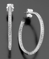 A row of fully faceted crystal accents add luminous sophistication to these otherwise classic hoop earrings. In rhodium-plated silvertone mixed metal. Each measures approximately 1-1/4 inches in diameter.