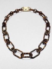 Make a statement with this tortoise-pattern acetate chain link design. Tortoise-pattern acetateGoldtone brassLength, about 34Turn-lock closureImported 