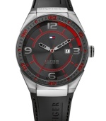 Bold color gives this casual watch from Tommy Hilfiger a modern air. Crafted of black silicone strap and round stainless steel case with logo. Black bezel features red numerals and stick markers. Black dial features silver tone numerals at three, six, nine and twelve o'clock, tachymeter scale, red inner minute track and stick markers, cut-out silver tone hour and minute hands, red second hand, date window at three o'clock and iconic flag logo at twelve o'clock. Quartz movement. Water resistant to 50 meters. Ten-year limited warranty.