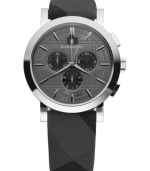 This Burberry watch features a beat check fabric strap and round stainless steel case. Chronograph dark gray engraved dial with silvertone stick indices, logo, date window and three subdials. Swiss made. Swiss movement. Water resistant to 50 meters. Two-year limited warranty.