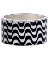 Infuse your look with the wild colors and funky patterns of Brasil. Crafted in silver tone mixed metal Haskell's Streets bangle features black and white wavy stripes and a hinge clasp. Approximate diameter: 2-1/2 inches. Approximate length: 8 inches. Item comes packaged in a turquoise gift box.