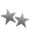 Shine bright, superstar! GUESS's sparkling star-shaped stud earrings dazzle with pave-set glass accents in silver tone mixed metal. Approximate diameter: 1-3/4 inches.