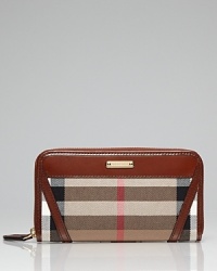 Sleek and city cool. This zip around wallet from Burberry is an style set essential, with ample pockets for on-the-go allure. Sleek and city cool. This zip around wallet from Burberry is an style set essential, with ample pockets for on-the-go allure.