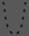 Mysterious loveliness. Show your dark side with this necklace with black onyx beads (4-10 mm). Set in sterling silver. Approximate length: 18 inches.