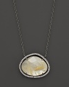 Diamonds circle a faceted yellow quartz and mother-of-pearl doublet set in blackened sterling silver. By Di Massima.