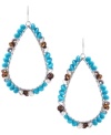 Bask in the beaded turquoise glory. Kenneth Cole New York's silver tone orbital drop earrings feature pretty little turquoise, brown and silver tone beads that are made of plastic, wood, and metal. Approximate drop: 2-1/2 inches.