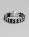 Architectural drama defines this bold bracelet, constructed of double rows of black onyx beads held by scalloped pillars of sterling silver. Black onyx Sterling silver Length, about 8¾ Lobster clasp Imported