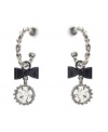 Chic hoops with an extra touch of flirtation. Betsey Johnson earrings feature quarter hoops decorated with bow and round-cut crystal charms. Crafted in silver tone mixed metal. Approximate drop: 2 inches.