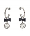 Chic hoops with an extra touch of flirtation. Betsey Johnson earrings feature quarter hoops decorated with bow and round-cut crystal charms. Crafted in silver tone mixed metal. Approximate drop: 2 inches.
