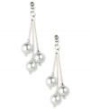 Start your date night with confidence with these elegant drop earrings by Anne Klein. Three white plastic pearls are suspended from glass stone-accented posts. Crafted in imitation rhodium-plated mixed metal. Approximate drop: 2 inches.