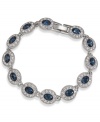 A fashionista's dream. This Carolee bracelet features oval-cut blue glass stones surrounded by smaller clear accents. Linked together in a silver tone imitation rhodium mixed metal setting. Approximate length: 7 inches.