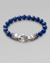 A welcome touch of color, strung with 10mm lapis beads and a raven's head sterling silver clasp.About 9¼ long Imported