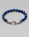 A welcome touch of color, strung with 10mm lapis beads and a raven's head sterling silver clasp.About 9¼ long Imported