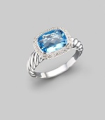 From the Noblesse collection. A glimmering blue topaz, surrounded by diamonds, balances elegantly on a cable band of sterling silver. Diamonds, 0.21 tcw Blue topaz Sterling silver Imported