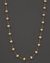 Textured bead stations lend bold style to this 18 karat gold necklace from Marco Bicego.