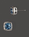 Diamonds frame faceted blue topaz, set in 14K yellow gold.