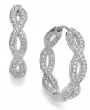 Get in the mix. Eliot Danori's traditional hoop earrings take an unexpected twist with an intertwining design embellished with crystal accents. Set in rhodium-plated silver tone mixed metal. Approximate diameter: 1 inch.