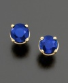 A round-cut sapphire (1 ct. t.w.) cradled in polished 14k gold 4-prong setting.