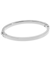 Complement your look with the perfect finishing touch. Michael Kors' polished bangle features a silver tone mixed metal setting and easy-to-use hinge clasp. Approximate diameter: 2-1/4 inches. Approximate width: 1/8 inch.