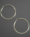 Smooth, sultry and stylish, these 14k gold hoop earrings always elevate your style. Approximate diameter: 1/2 inch.