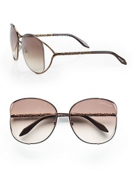 A chic metal style with intricately detailed temples and modern floating lens. Available in brown with brown gradient lens. Logo etched lens100% UV protectionMade in Italy A chic metal style with intricately detailed temples and modern floating lens. Available in brown with brown gradient lens. Logo etched lens100% UV protectionMade in Italy