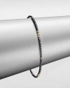 A simple chic piece that features faceted beads in blackened sterling silver accented with eight, 14k gold beaded sections. Blackened sterling silver14k goldDiameter, about 2.5Slip-on styleMade in USA