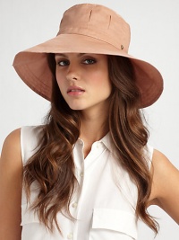 Wide brim cotton organdy with pleated crown and split back brim is perfect for travel or a day at the beach.Adjustable drawstring ties One size fits most Brim, about 4 wide Cotton; dry clean Imported 