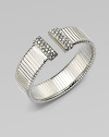 An elegantly ribbed, flexible cuff with Swarovski crystal caps.CrystalSilverplatedDiameter, about 2¼Made in Italy