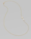 A wispy chain of 14k yellow gold features a cross pendant, punctuated by a single sparkling diamond, set askew for a modern edge.Diamond, .02 tcw 14k yellow gold Length, about 16 Pendant length, about ¾ Spring ring clasp Made in USA