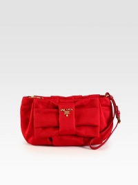 Tessuto nylon design with logo detail and bow.Adjustable wristlet strap, 5½-6 dropTop zip closureSignature jacquard lining8W X 6¼H X 1DMade in Italy Tessuto nylon design with logo detail and bow.Adjustable wristlet strap, 5½-6 dropTop zip closureSignature jacquard lining8W X 6¼H X 1DMade in Italy