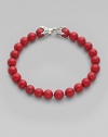Smooth, polished coral beads are laced on a sterling silver chain. From the Spiritual Bead Collection Sterling silver Coral 8mm beads About 8½ long Lobster clasp Imported 