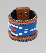 A wide cuff of bright leather, edged with golden beads and chains, stitched in colorful cord, with a center bugle-bead design.LeatherGoldtoneCotton backingLength, about 8½Width, about 2¾Stud snap closureImported