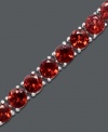 Vibrantly versatile. Ruby red stones of round-cut garnet (20 ct. t.w.) make a mark in your corporate or casual lifestyle. Bracelet crafted in sterling silver. Approximate length: 7 inches.