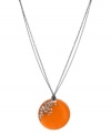 Icy accents blend with warm color. This Kenneth Cole New York necklace features a circular orange resin pendant accented by crystal accents. Set in silver tone mixed metal. Approximate length: 16 inches + 3-inch extender. Approximate drop: 1-3/4 inches.