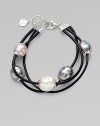 This three-row piece is a beautiful mix of lustrous pearls on sturdy black leather cord. 12mm Baroque white, grey and nuage organic man-made pearls with sterling silver capsLeather cord Lobster clasp closureLength, about 7½Imported 