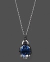 Black and white diamonds frame a faceted London blue topaz, set in 14K white gold.