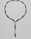 A strand of large and small black onyx beads, interspersed with textured sterling silver beads, with a Y-shaped drop, capped by a dramatic carved raven's head. Black onyx Sterling silver Length, about 15 Drop, about 4 Lobster clasp Imported