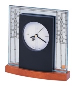 Adapted from the art glass window in the living room of the W. A. Glasner House in Glencoe, Illinois, circa 1905, this desk clock from the Frank Lloyd Wright collection is a contemporary conversation piece. Etched glass and round dial featuring three hands is set in a solid wood base with light cherry stain.