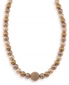 Classy with a hint of shimmer, this adjustable glass pearl necklace by Carolee adds an element of glamour. Comprised of gold glass pearls (8 mm) and a crystal coated fireball, necklace features a 12k gold-plated mixed metal setting. Approximate length: 16 inches + 2-inch extender.